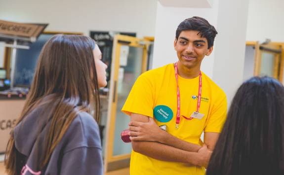 A prospective student talking to a current student at an event